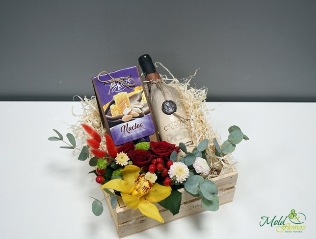 Box of flowers, wine, and chocolate candies photo